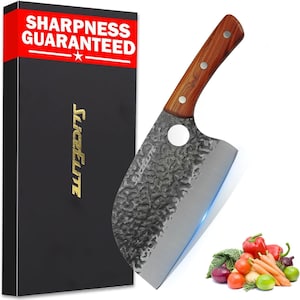 May include: A cleaver knife with a textured dark metal blade, a circular hole, and a brown wooden handle with three rivets. The knife is positioned next to a black box featuring the text SHARPNESS GUARANTEED and SLICEELITE, alongside fresh vegetables.