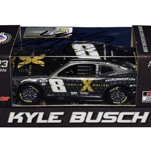 Könnte beinhalten: Ein Modell eines NASCAR-Rennwagens in einer schwarzen Box. Das Auto ist schwarz mit weißen und goldenen Akzenten, einschließlich der Nummer 8. Auf der Box steht "Kyle Busch" und "2023 Season".