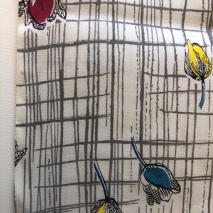 May include: White fabric with a gray grid pattern and colorful tulip illustrations. The tulips are red, yellow, and blue.