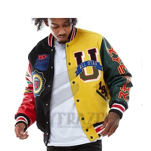 May include: Varsity jacket with a color-block design. The jacket features a yellow and black body with red and green sleeves. Patches with text and graphics are on the chest and sleeves. The jacket has a button-up front and striped cuffs.