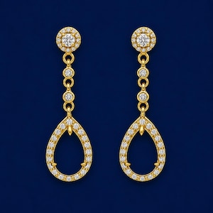 May include: A pair of gold drop earrings featuring a circular stud top with a central round stone surrounded by small pavé diamonds. A vertical chain of two small circular links connects to a large pear-shaped open frame set with round diamonds.