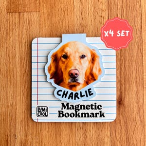 May include: A magnetic bookmark featuring a golden retriever dog named Charlie. The bookmark has a blue and white lined paper design with the text "Magnetic Bookmark" and the Lumi Cool logo. A red sticker indicates it's a set of four.