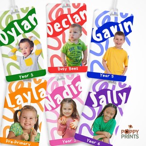 May include: Six rectangular luggage tags featuring individual photographs of children. Each tag displays a name in a bold font, a colorful abstract background pattern, and a bottom color-coded bar with text including Year 3, Busy Bees, Year 5, Pre-Primary, Year 1, and Year 6. The Poppy Prints logo is visible in the bottom right corner.
