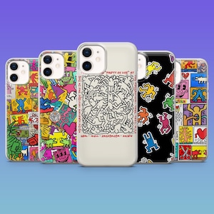 May include: A selection of phone cases with vibrant pop art designs. The cases showcase diverse graphics, such as dancing figures, cartoon faces, and abstract patterns. One case features the text "PARTY OF LIFE AT" and "KEITH HARING INVITES YOU TO THE MAYEE - WEDNESDAY - 11PM - 1985".