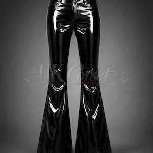 May include: Black high-waisted pants with a glossy, patent-like finish. These trousers feature a fitted waist and hip area that transitions into a wide, flared leg silhouette. The design includes a front button closure and classic pocket detailing.