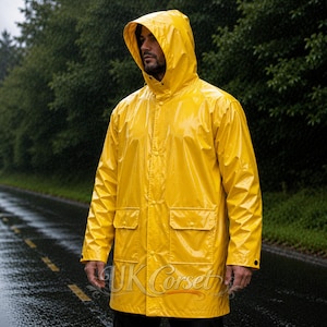 Könnte beinhalten: Ein leuchtend gelber Regenmantel mit Kapuze, langen Ärmeln und zwei Vordertaschen mit Klappen. Die Jacke ist mit einer glatten, glänzenden Oberfläche gefertigt und verfügt über eine mittige vertikale Reihe von Druckknöpfen zum Verschließen.