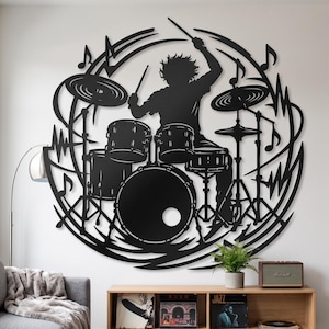 May include: A circular black metal wall art piece featuring a silhouette of a drummer playing a drum kit. The design includes musical notes and abstract sound wave lines surrounding the central figure, creating a dynamic and rhythmic visual composition.