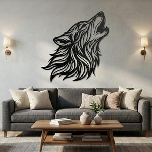 May include: A black metal wall art piece depicting a howling wolf. The wolf's head is rendered in a stylized, flowing design, with intricate details in its fur. The artwork is mounted on a light-colored wall above a gray sofa.
