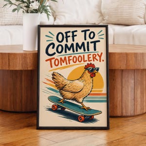 May include: A rectangular framed wall art print featuring a light brown chicken wearing dark sunglasses while riding a teal skateboard. The text reads OFF TO COMMIT TOMFOOLERY. The background includes a yellow sun and horizontal stripes in blue and orange.