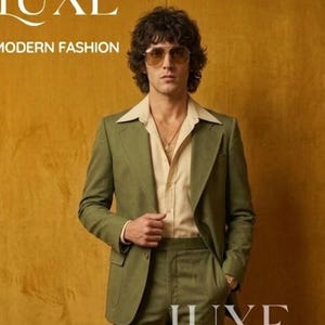 May include: A man in a green suit with a cream-colored shirt. The suit has a wide lapel and a two-button closure. The text "LUXE MODERN FASHION" is at the top. The word "LUXE" is also at the bottom. The background is a mustard yellow color.