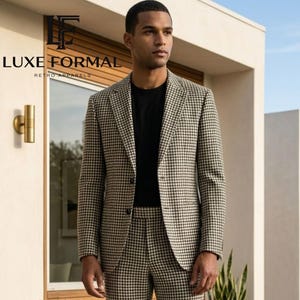 May include: A two-piece houndstooth suit in black and tan, paired with a black crew neck shirt. The suit features a classic notched lapel and straight-leg trousers. The brand name "LUXE FORMAL RETRO APPARELS" is visible in the image.