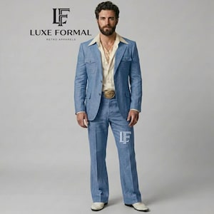 May include: A light blue suit featuring a blazer with two chest pockets and matching trousers, worn with a cream-colored button-down shirt. The ensemble includes a gold belt buckle and a gold necklace. The text LUXE FORMAL RETRO APPARELS is visible.