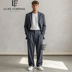 May include: A charcoal gray suit consisting of a single-breasted blazer with notched lapels and matching pleated trousers, worn over a plain white crew-neck t-shirt. The text LUXE FORMAL RETRO APPARELS appears in the upper left corner of the image.