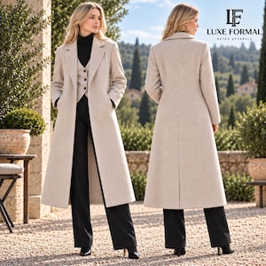 May include: A long, beige wool-blend coat worn over a black turtleneck, a buttoned vest, and black trousers. The coat features notched lapels and long sleeves. The image includes the text LUXE FORMAL RETRO APPARELS in the upper right corner.