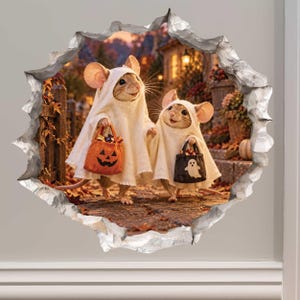 May include: A wall decal featuring two mice dressed in white ghost costumes for Halloween. One mouse carries an orange pumpkin-shaped treat bag, while the other holds a black bag with a white ghost print. The scene is framed by a jagged hole effect.