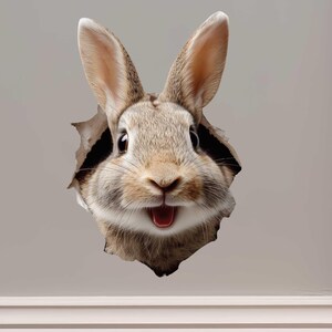 May include: A brown and tan rabbit head emerging from a torn hole in a gray wall. The rabbit has long ears, a pink mouth, and a surprised expression. The image is a whimsical, decorative design.
