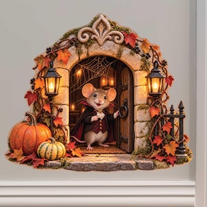 May include: A wall decal featuring a stone archway entrance with a mouse dressed in a vampire cape standing in the doorway. The scene includes two lit lanterns, orange pumpkins, autumn leaves, a spider web, and a small black metal fence.