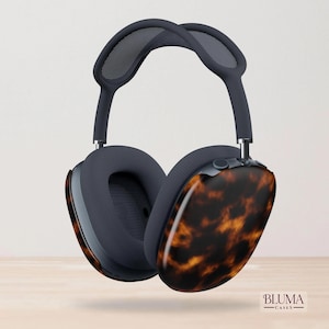May include: Over-ear headphones featuring a dark gray frame, mesh headband, and ear cushions with a glossy brown and black tortoiseshell pattern on the outer shells. The text BLUMA CASES is printed in the bottom right corner of the image.