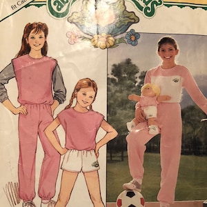 May include: Vintage Butterick sewing pattern for Cabbage Patch Kids outfits. The pattern features illustrations of children wearing pink and white athletic wear. The package includes the text "FREE PATTERN" and "BONUS! Iron-on Transfers Included."