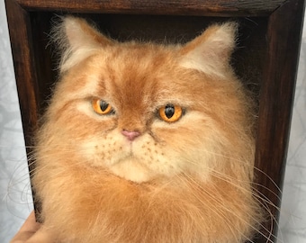 May include: A needle felted portrait of a ginger cat with orange eyes, framed in a dark wood frame.
