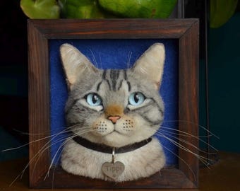 May include: A framed needle felted portrait of a gray tabby cat with blue eyes. The cat is wearing a black collar with a silver heart-shaped tag that says "Tippi".