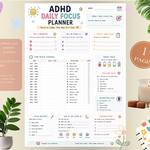 May include: A white ADHD Daily Focus Planner sheet featuring sections for top priorities, a time block schedule from 6 AM to 10 PM, an energy check, a self-care plan, a distraction plan, focus boosters, an end of day check-in, and tomorrow prep.