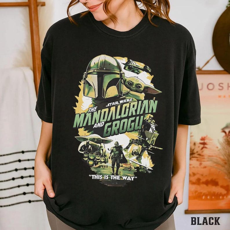 May include: Black t-shirt with a Star Wars graphic featuring the Mandalorian and Grogu. The design includes the Mandalorian's helmet, Grogu, and the phrase "THIS IS THE WAY."