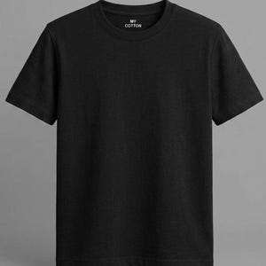 May include: A solid black crew neck t-shirt. The shirt has short sleeves and a simple, classic design. The text "MY COTTON" is printed in white on the upper chest area.