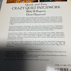 May include: Book cover for "Quick-and-Easy Crazy Quilt Patchwork with 14 Projects" by Dixie Haywood. The cover features a blue and white crazy quilt with a floral pattern. The book is a Dover publication and includes instructions on how to make crazy quilts.