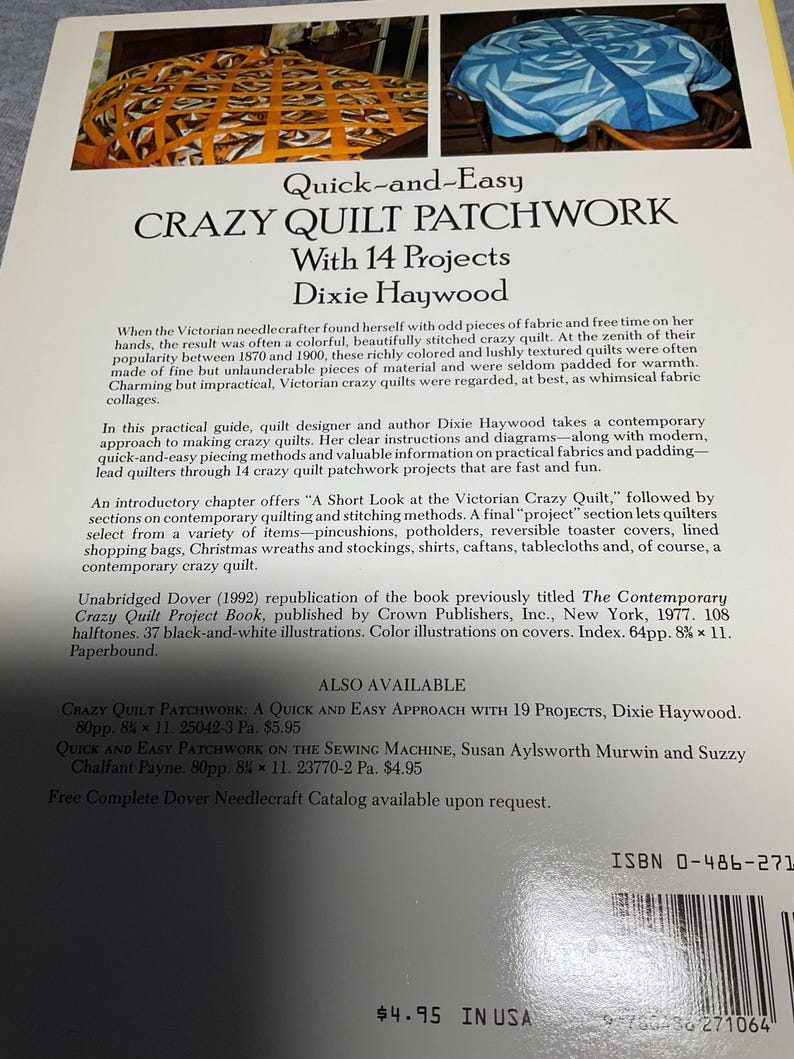 May include: Book cover for "Quick-and-Easy Crazy Quilt Patchwork with 14 Projects" by Dixie Haywood. The cover features a blue and white crazy quilt with a floral pattern. The book is a Dover publication and includes instructions on how to make crazy quilts.