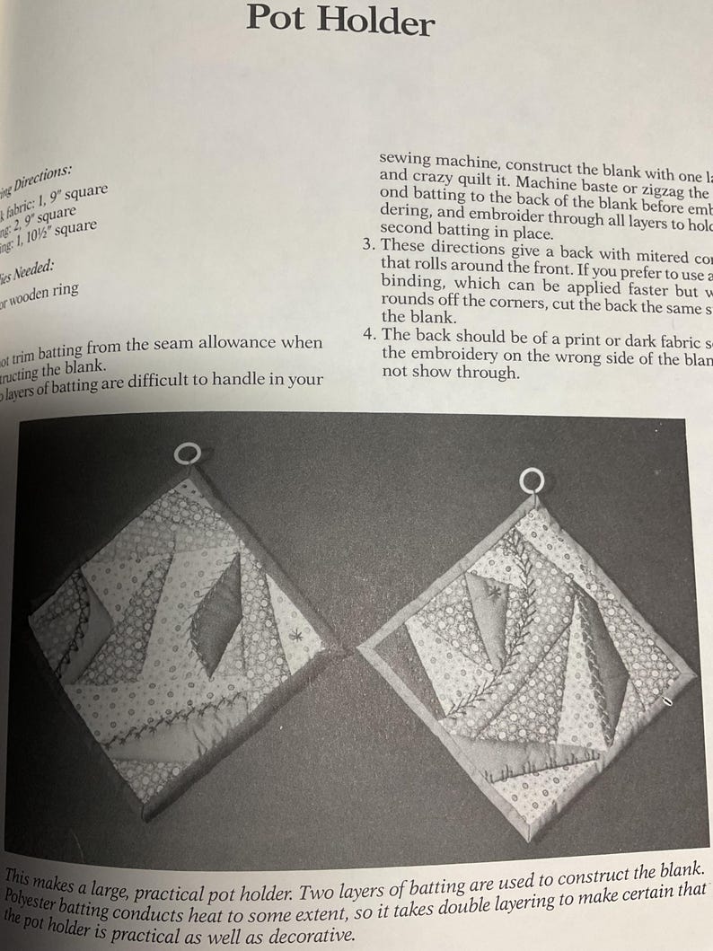 May include: Two black and white quilted pot holders with a geometric pattern. The pot holders are made with two layers of batting and are designed to be practical and decorative.