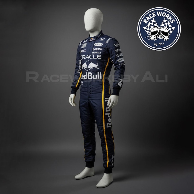 May include: A navy blue racing suit with yellow stripes and sponsor logos, including "Red Bull" and "Oracle." The suit is displayed on a mannequin. The image also includes a circular logo with checkered flags and the text "Race Works by ALI."