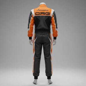 May include: A racing suit in black, orange, and white. The jacket has "Surname" and "ORG" printed on the back. The suit features white and orange stripes down the sides of the pants and sleeves. The suit is displayed on a mannequin.