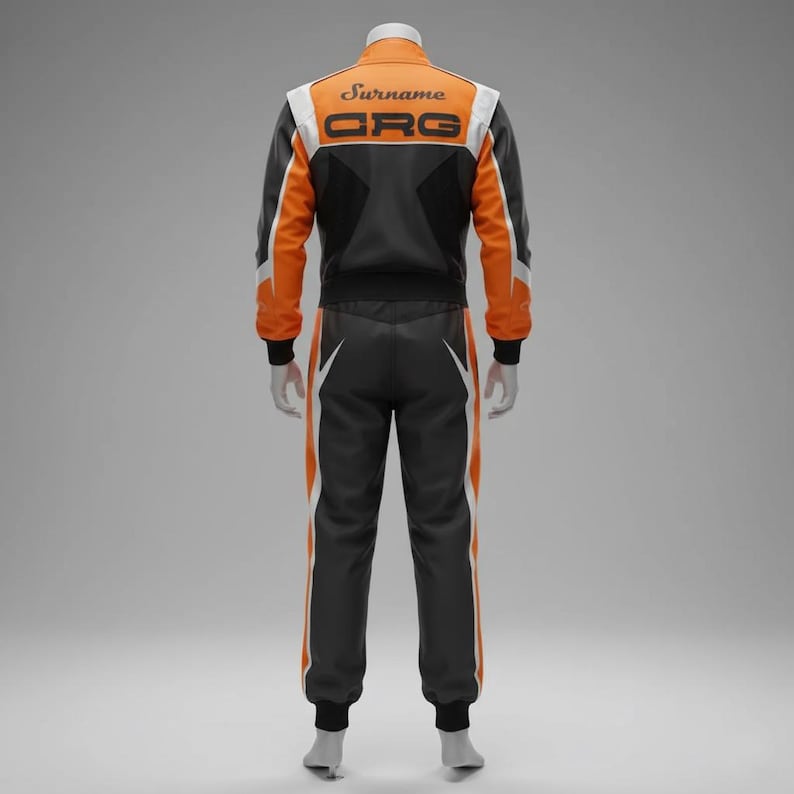 May include: A racing suit in black, orange, and white. The jacket has "Surname" and "ORG" printed on the back. The suit features white and orange stripes down the sides of the pants and sleeves. The suit is displayed on a mannequin.
