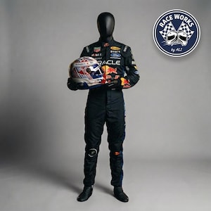 May include: A black racing suit featuring various sponsor logos and a red bull graphic, worn by a mannequin holding a racing helmet with a Union Jack pattern. A circular logo in the top right corner displays the text RACE WORKS by ALI with two helmets.