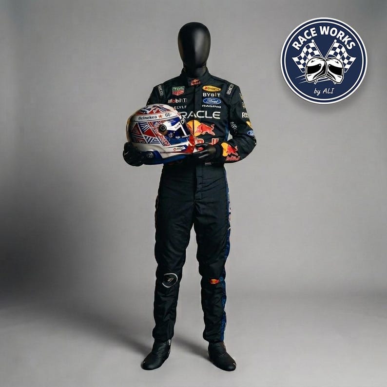 May include: A black racing suit featuring various sponsor logos and a red bull graphic, worn by a mannequin holding a racing helmet with a Union Jack pattern. A circular logo in the top right corner displays the text RACE WORKS by ALI with two helmets.