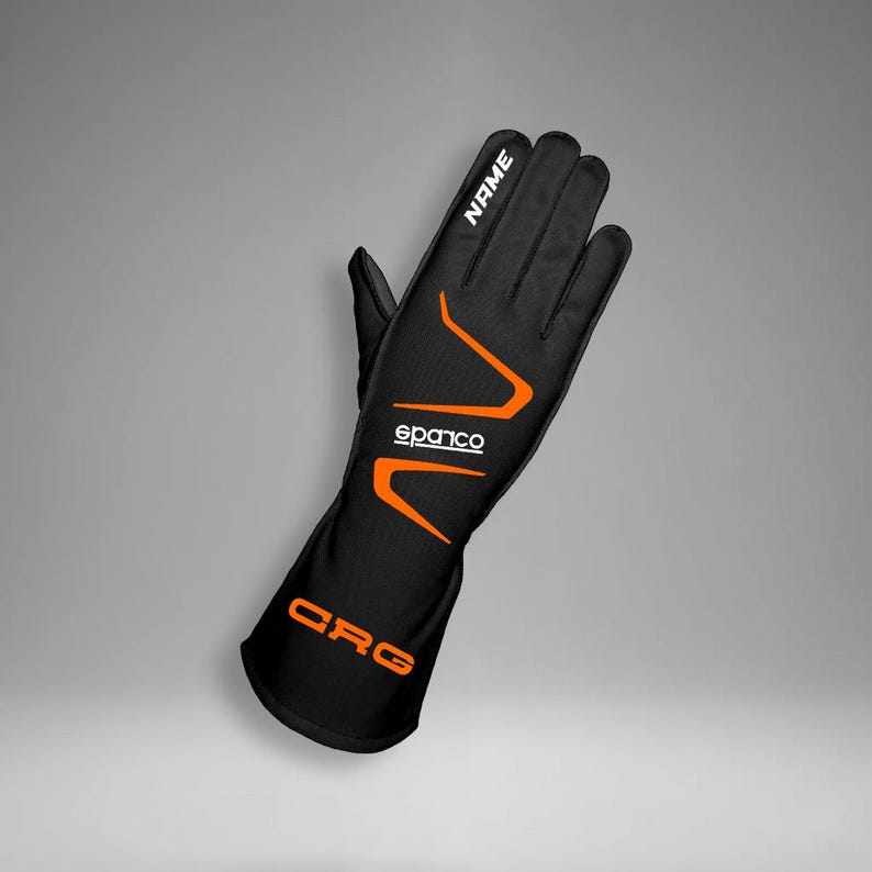 May include: Black racing glove with orange accents and the text "NAME" in white. The glove features the "sparco" logo and "CRG" text in orange. The glove is designed for motorsports.