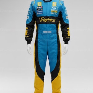 Puede incluir: Mono de carreras azul, negro y amarillo con logotipos de patrocinadores y la palabra "Telefonica" en el pecho. El mono se exhibe en un maniquí. El nombre "FRANCO LUISSI" está impreso en la cintura.