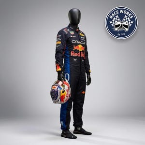 May include: A dark navy blue and black racing suit featuring multiple sponsor logos including Oracle and Red Bull, worn by a mannequin holding a white, red, and blue racing helmet. A circular logo in the top right corner reads RACE WORKS by ALI.
