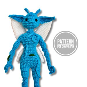 May include: A bright blue crocheted creature with large pointed ears, white wings, and small dark eyes. The figure features spiral details on the chest and limbs, with small green accents. A circular graphic to the right reads PATTERN PDF DOWNLOAD.