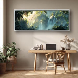 May include: A framed landscape art print depicts a lush tropical waterfall scene. The artwork, encased in a white frame, showcases a vibrant waterfall cascading through dense green foliage, with sunlight filtering through the trees. The print is displayed above a wooden desk.