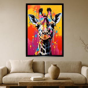 May include: A framed pop art style painting of a giraffe's head. The giraffe is depicted with vibrant colors, including yellow, orange, pink, blue, and black. The background features colorful paint splatters, adding to the artwork's dynamic and modern aesthetic.