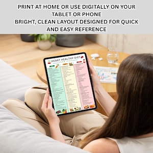 May include: A tablet displaying a colorful "Heart Healthy Diet" food list. The screen shows a bright, clean layout with sections for vegetables, grains, and fruits. Text at the top reads: "Print at home or use digitally on your tablet or phone."