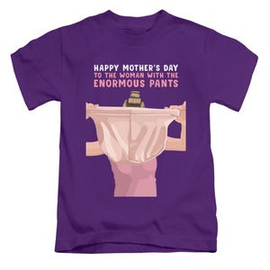 May include: A purple t-shirt featuring the text "HAPPY MOTHER'S DAY TO THE WOMAN WITH THE ENORMOUS PANTS". The graphic depicts a person holding up large underwear. The shirt is a children's size.