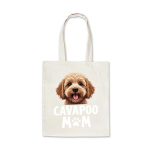 May include: Cream-coloured canvas tote bag with a brown Cavapoo dog illustration. The text "Cavapoo Mom" is printed below the dog image, along with a paw print. The bag has two handles.