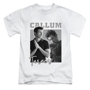May include: White t-shirt with a black and white image of two men. The word "CALLUM" is printed in grey block letters above the image. The name "Turner" is written in cursive below the image.