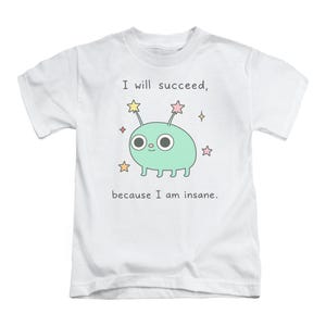 May include: White t-shirt with a cartoon alien and the text "I will succeed, because I am insane." The alien is light green with large eyes, antennae, and is surrounded by colourful stars.