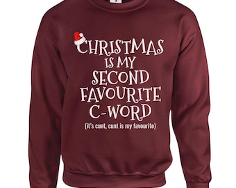 Peut inclure: Un sweat-shirt bordeaux avec le texte "CHRISTMAS IS MY SECOND FAVOURITE C-WORD (it's cunt, cunt is my favourite)" en blanc. Un petit chapeau de Père Noël est au-dessus du mot "CHRISTMAS".