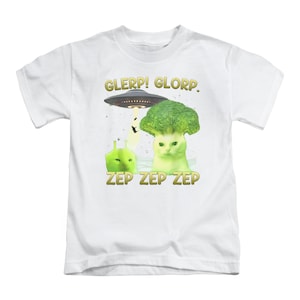 May include: White t-shirt with a humorous design. It features a cat with a broccoli crown, an alien, and a UFO. The text "GLERP! GLORP." and "ZEP ZEP ZEP" are printed in gold.