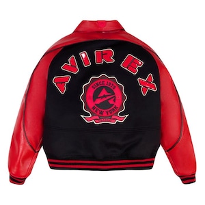 May include: A red and black varsity jacket featuring red leather sleeves and a black wool-like body. The back displays the text AVIREX in red letters above a circular emblem with the text SINCE 1975 NEW YORK CLASSIC. The jacket has a ribbed collar, cuffs, and hem with red and black stripes.